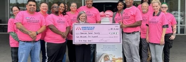 Car-Mart associates posing for picture in Woodstock, Georgia holding big Check for Donation to the American Cancer Society 2023