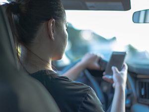 Safe driving. Women on her cell phone while driving.