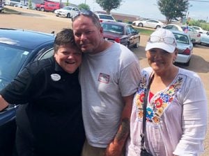 Car-Mart of Oxford General Manager, Pat Stutsy-Waldrep with customers.