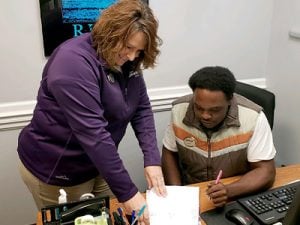 Christy Godsey-Price meeting with an associate.