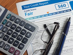 Building credit blog. Your credit report with calculator, eyeglasses, and pen.