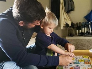 Josh playing educational game with his son