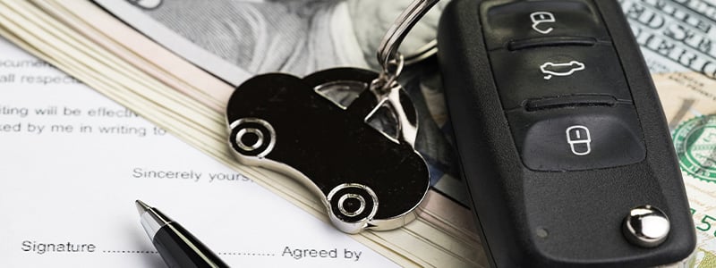 Auto Financing; car keys, money and a contract