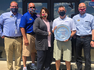 Car-Mart leadership posing for a group photo with Todd Dobson, GM at Jonesboro, the winner of Car-Mart Lot of the Year