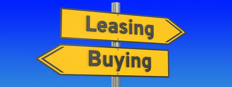 buying versus leasing street sign