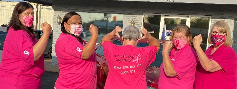 Mary wearing a "They got my six" shirt with the Car-Mart of Claremore team wearing pink shirts