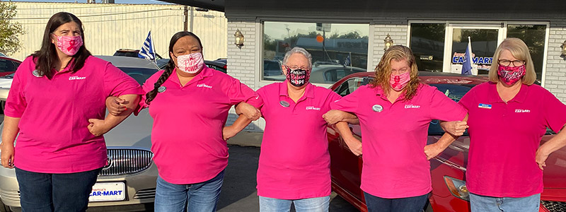 The Car-Mart of Claremore team wearing pink shirts