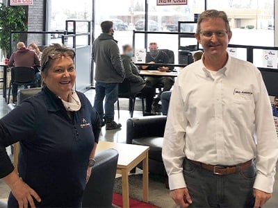 Amy Mullins, Area Operations Manager in Benton, standing with Steve Taylor inside a dealership