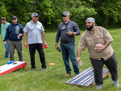 Pedro and other Car-Mart associates playing corn hole