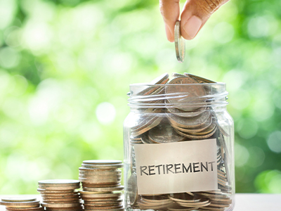 adding coins to a jar saving for retirement