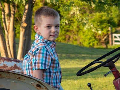 Zakariah on a tractor