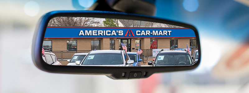 Car-Mart dealership in car rearview mirror