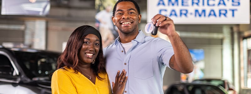 happy african american couple holding car keys