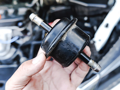 A person holding a car fuel filter