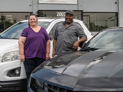 Robbie and Ricky McKoy with their two newest cars from Car-Mart