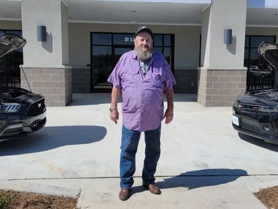 O.C. Branson in front of Car-Mart of Siloam Springs