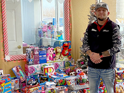Tommy Tompkins, General Manager at Ardmore, with the toys collected at Car-Mart of Ardmore