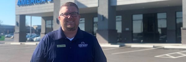 Cole Henry, General Manager at America’s Car-Mart of Sedalia, Mo. standing in front of his new dealership