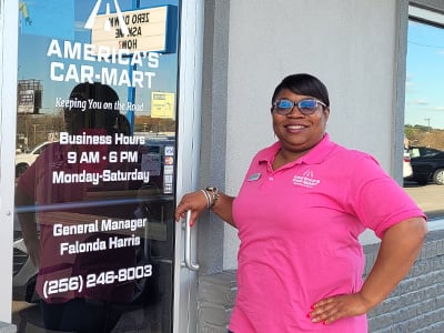 Falonda Harris, General Manager, Car-Mart of Florence, Ala. standing by the front door of the Florence dealership