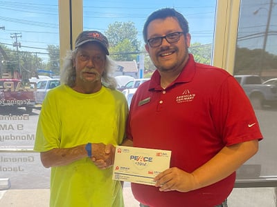 Car-Mart customer, Doug Childress, shakes hands with Jacob Terry, General Manager at Car-Mart of Springfield North