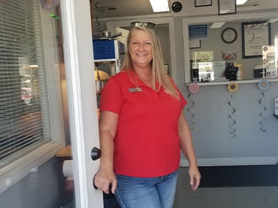 Car-Mart of West Plains General Manager Pamela Turley opens the door to her dealership. And she’s always thrilled to see customers Mike and Heidi Dudley.