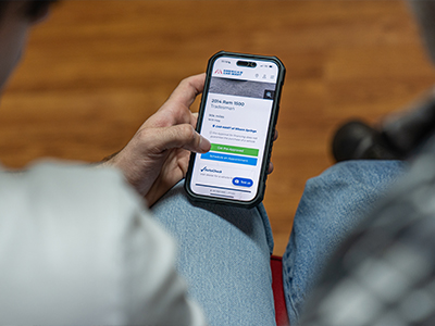 Father and son looking for a vehicle online and starting the credit application process.