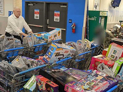 An OPENLANE associate filling up shopping carts for the toy drive.