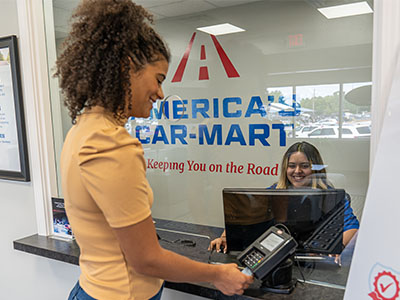 Woman making a vehicle payment at a Car-Mart location
