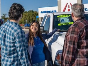 Female Car-Mart Associate Guiding Customer Through the Sales Process
