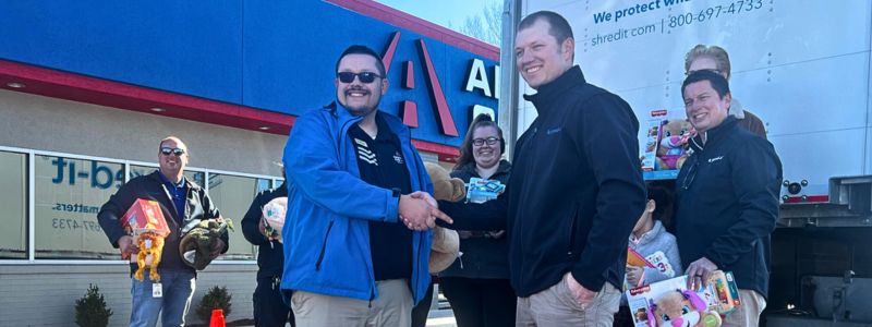 Car-Mart GM Shaking Hands with Partner at 15th Annual Holiday Toy Drive