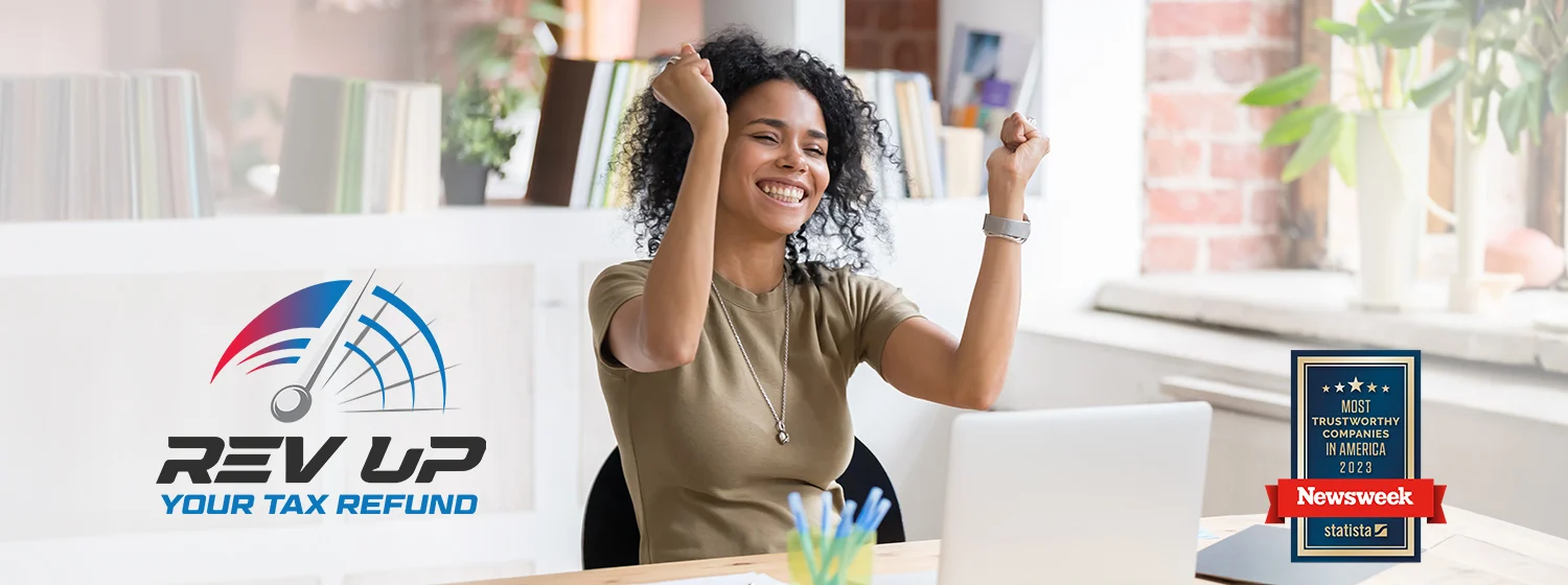 Woman sitting at a laptop and celebrating good news