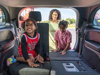 Woman and children looking at vehicle options at Car-Mart